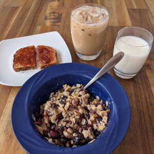 Pre-ride breakfast of champions.  Oatmeal loaded with pecans, walnuts, raisins, dried cranberries, and honey.  Whole wheat Dave's Good Seed toast with strawberry jam.  Glass of milk and iced coffee.